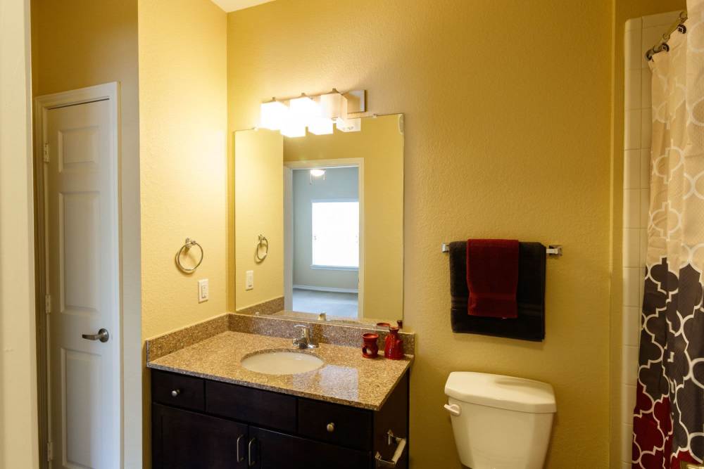 Bathroom with a large counter at North Court Villas in Frisco, Texas