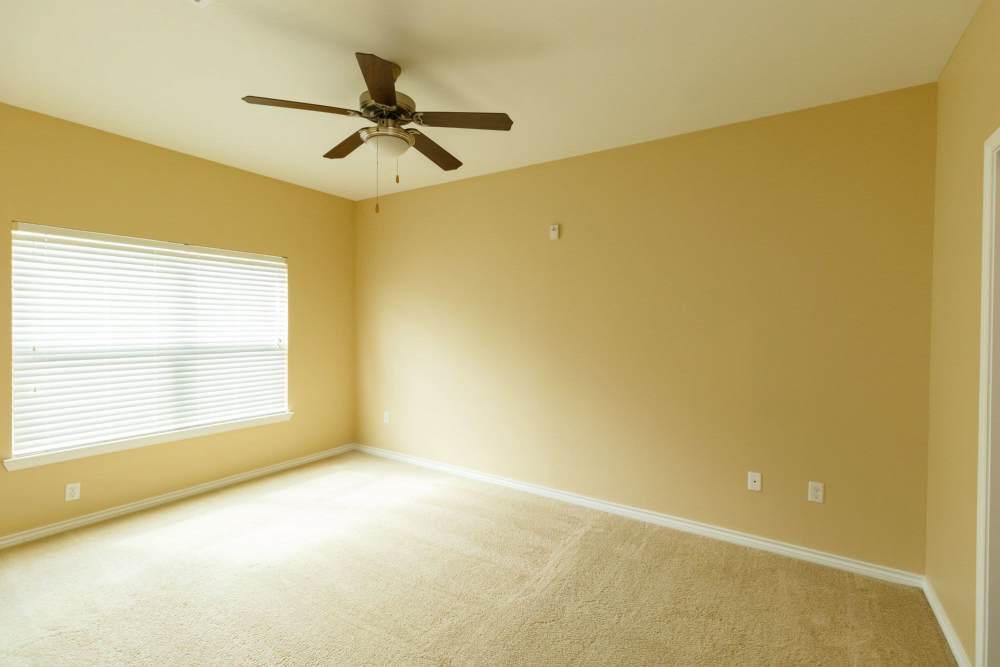 Model bedroom with soft carpet at North Court Villas in Frisco, Texas