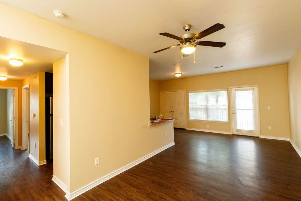 Open layout living room with hard-wood style flooring at North Court Villas in Frisco, Texas