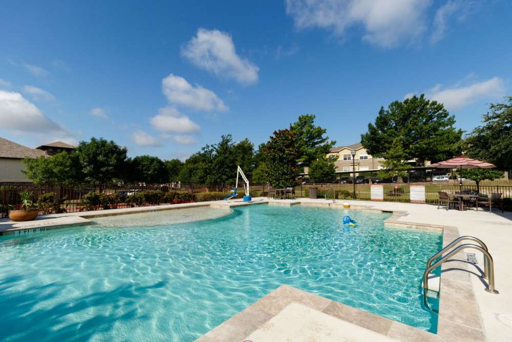 Sparkling saltwater swimming pool and lounge beds at North Court Villas in Frisco, Texas